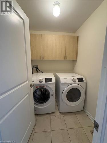 Laundry room featuring washer and dryer and cabinet space - 50 Shoreacres Drive, Kitchener, ON - Indoor Photo Showing Laundry Room
