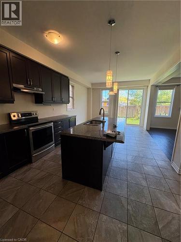 Kitchen featuring stove, hanging light fixtures, a center island with sink, and healthy amount of natural light - 50 Shoreacres Drive, Kitchener, ON - Indoor Photo Showing Kitchen