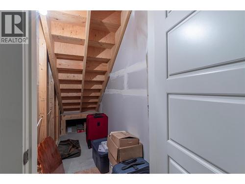 Storage under stairs in basement - 2372 Oglow Drive, Armstrong, BC - Indoor Photo Showing Other Room