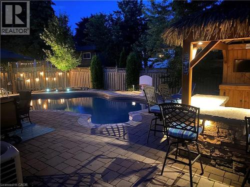 Pool at twilight featuring a fenced backyard and a patio - 3354 Bristol Drive, Burlington, ON - Outdoor With In Ground Pool With Deck Patio Veranda