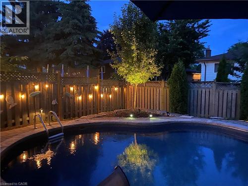 Pool at twilight with a fenced backyard - 3354 Bristol Drive, Burlington, ON - Outdoor With In Ground Pool