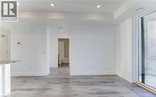 Unfurnished room with light wood finished floors and recessed lighting - 103 Roger Street Unit# 310, Waterloo, ON - Indoor Photo Showing Other Room