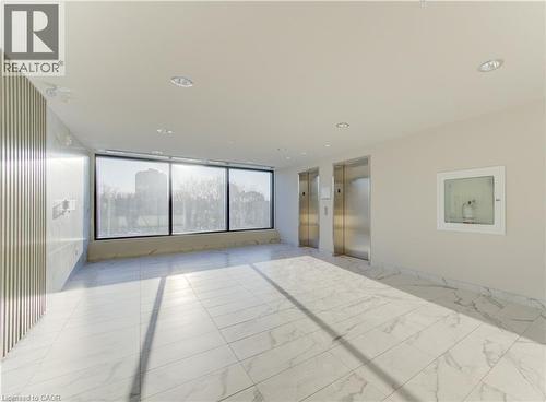 Spare room with elevator and expansive windows - 103 Roger Street Unit# 310, Waterloo, ON - Indoor Photo Showing Other Room