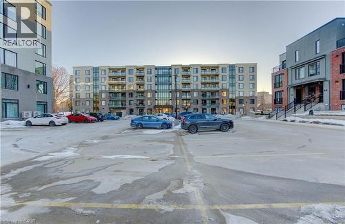 View of uncovered parking lot - 103 Roger Street Unit# 310, Waterloo, ON - Outdoor With Facade