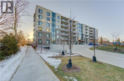 Property at dusk featuring a view of apartment building / complex - 103 Roger Street Unit# 310, Waterloo, ON - Outdoor With Facade