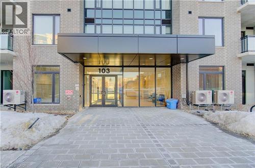 Property entrance with french doors and brick siding - 103 Roger Street Unit# 310, Waterloo, ON - Outdoor With Balcony