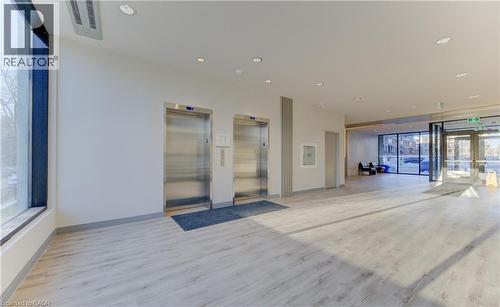 Building lobby with recessed lighting and floor to ceiling windows - 103 Roger Street Unit# 310, Waterloo, ON - Indoor Photo Showing Other Room