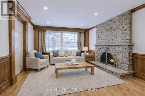 Virtually Staged Family Room Sitting Area - 1585 Crombie Road, Mississauga, ON - Indoor Photo Showing Living Room With Fireplace