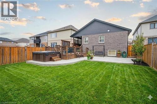 Rear view of property featuring a hot tub, a fenced backyard, and a patio area - 117 Monarch Street, Welland, ON - Outdoor With Deck Patio Veranda