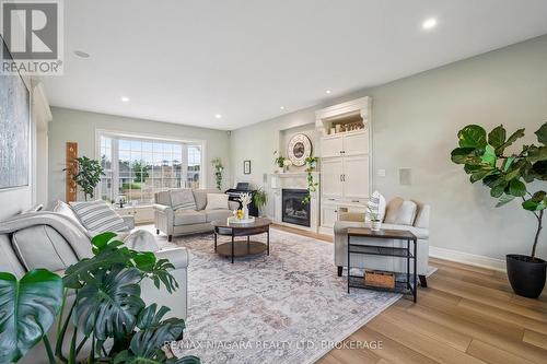 Built in speakers in ceiling, and hidden swivel TV - 2231 Seventh Street, St. Catharines (Rural Fourth), ON - Indoor Photo Showing Living Room With Fireplace