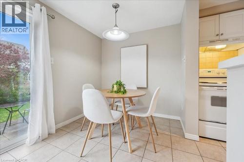 Dining space with healthy amount of natural light and light tile patterned floors - 66 Rodgers Road Unit# 2, Guelph, ON - Indoor Photo Showing Dining Room