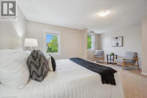 Carpeted bedroom with baseboards and a textured ceiling - 66 Rodgers Road Unit# 2, Guelph, ON - Indoor Photo Showing Bedroom