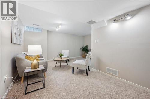 Living area with carpet floors and rail lighting - 66 Rodgers Road Unit# 2, Guelph, ON - Indoor