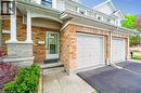 Property entrance featuring driveway, brick siding, a garage, and covered porch - 66 Rodgers Road Unit# 2, Guelph, ON  - Outdoor With Exterior 
