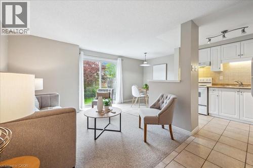 Living area featuring light tile patterned floors and baseboards - 66 Rodgers Road Unit# 2, Guelph, ON - Indoor