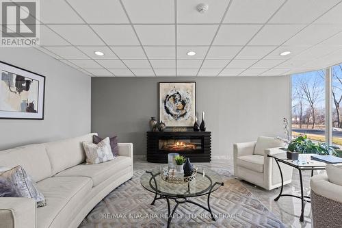 601 - 81 Scott Street, St. Catharines (Lakeport), ON - Indoor Photo Showing Living Room With Fireplace