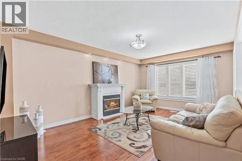 Living area featuring light hardwood flooring and a glass covered fireplace - 42 Archer Way, Hamilton, ON - Indoor Photo Showing Living Room With Fireplace