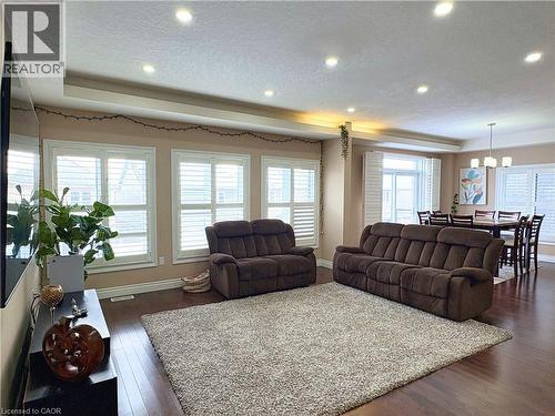 Living room with dark hardwood / wood-style flooring, a textured ceiling, and a wealth of natural light - 34 Watervale Drive Unit# Upper, Kitchener, ON - Indoor Photo Showing Living Room