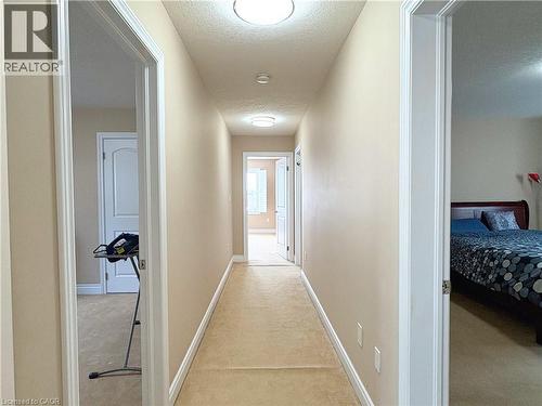 Hallway with light colored carpet and a textured ceiling - 34 Watervale Drive Unit# Upper, Kitchener, ON - Indoor Photo Showing Other Room