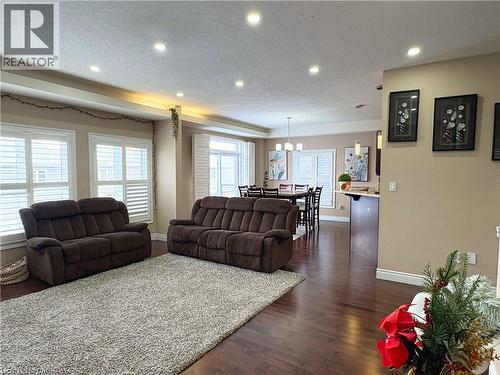 Living room with dark wood-type flooring and a textured ceiling - 34 Watervale Drive Unit# Upper, Kitchener, ON - Indoor Photo Showing Living Room