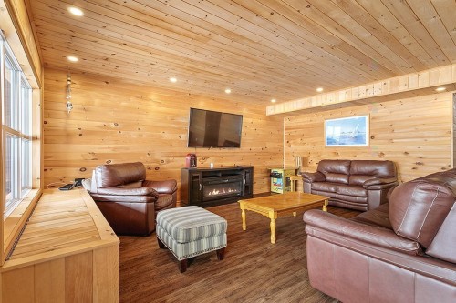 Salle familiale - 184 Ch. Flood, Litchfield, QC - Indoor Photo Showing Living Room With Fireplace