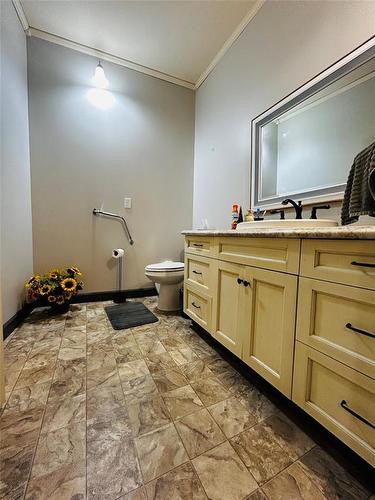 Toilet and sink area adjacent to the walk in shower area. - Pierson, Manitoba 