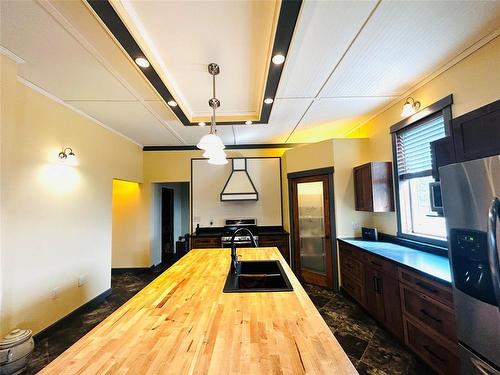 As we go back through the kitchen area we also have the laundry facilities with 2 pc, bath and the farther exit leading to mudroom and utility room. These homeowners had planned to make this a too... - Pierson, Manitoba 