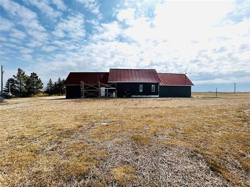 A view of the back side of the home. These homeowners did have a garden area at one time - still visible. - Pierson, Manitoba 