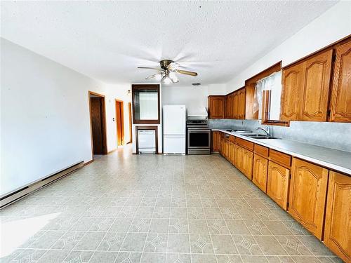 Very large eat in kitchen. - 244 Centennial Crescent, Melita, MB - Indoor Photo Showing Kitchen With Double Sink