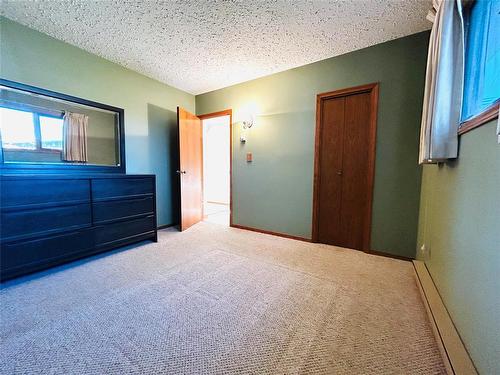 Primary bedroom on main level. - 244 Centennial Crescent, Melita, MB - Indoor Photo Showing Bedroom