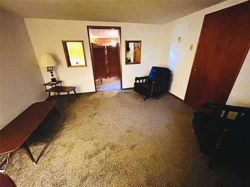 Lower level sitting area leading to the "saloon" with dry bar. - 244 Centennial Crescent, Melita, MB - Indoor Photo Showing Other Room