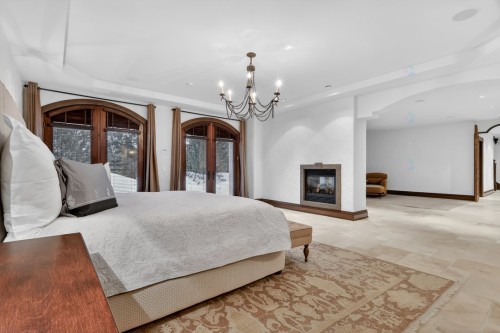 Master Bedroom - 1015 Ch. Cochrane, Mont-Tremblant, QC - Indoor Photo Showing Bedroom With Fireplace