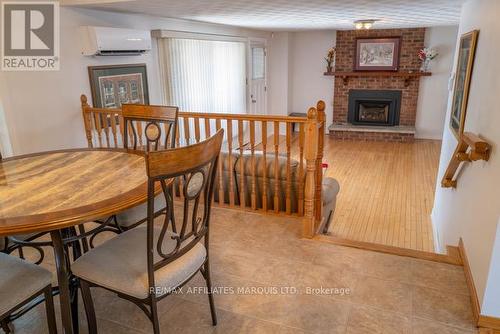 Dining room overlooks Family room w/ gas fireplace - 577 Lynwood Drive, Cornwall, ON - Indoor Photo Showing Dining Room With Fireplace