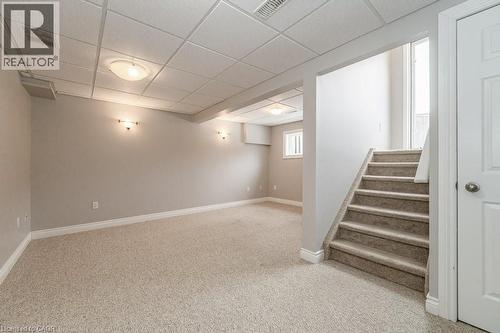 recreation room with sliding door at the top of the stairs for backyard access - 39 Brookfield Crescent, Kitchener, ON - Indoor Photo Showing Other Room