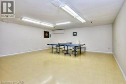 Recreation room featuring light floors and baseboards - 