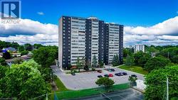View of apartment building / complex featuring uncovered parking - 