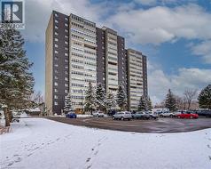 View of apartment building / complex featuring uncovered parking - 