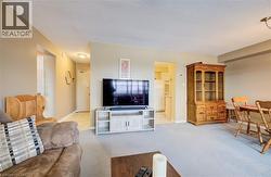 Living room with light carpet and a textured ceiling - 