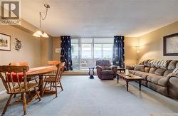 Dining area featuring light colored carpet and a textured ceiling - 