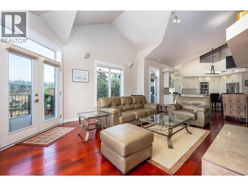 Large windows and sliding door - 375 Trumpeter Court, Kelowna, BC - Indoor Photo Showing Living Room