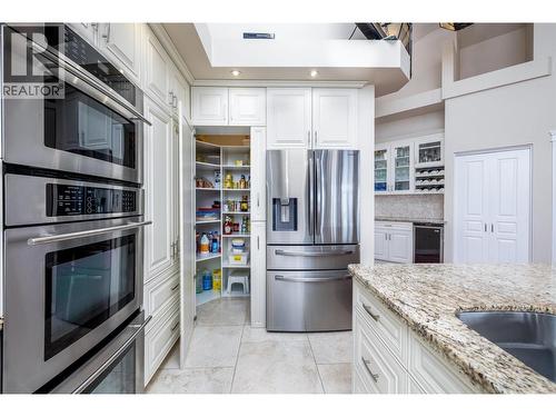 Large pantry hiding as part of the cabinet - 375 Trumpeter Court, Kelowna, BC - Indoor Photo Showing Kitchen With Double Sink With Upgraded Kitchen