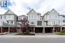 View of front of home with driveway, brick siding, an attached garage, and a residential view - 143 Ridge Road Unit# 48, Cambridge, ON  - Outdoor With Balcony With Facade 