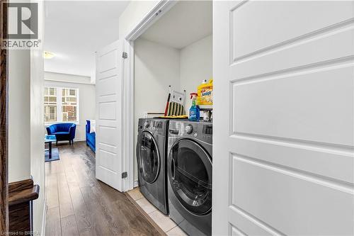 Laundry room featuring hardwood / wood-style flooring and washer and dryer - 143 Ridge Road Unit# 48, Cambridge, ON - Indoor Photo Showing Laundry Room