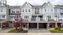 View of front of house featuring driveway, a residential view, a garage, brick siding, and a balcony - 143 Ridge Road Unit# 48, Cambridge, ON  - Outdoor With Facade 