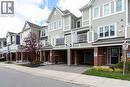 Traditional home with a residential view, brick siding, a carport, asphalt driveway, and a balcony - 143 Ridge Road Unit# 48, Cambridge, ON  - Outdoor With Balcony With Facade 