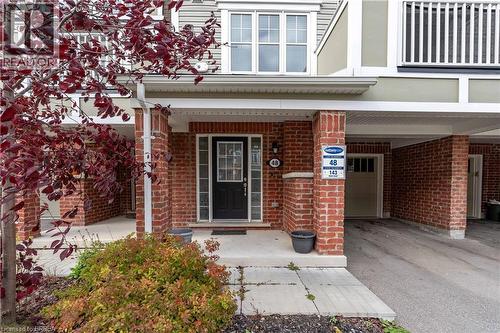 Entrance to property featuring covered porch, brick siding, and driveway - 143 Ridge Road Unit# 48, Cambridge, ON - Outdoor