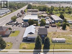 Aerial overview showcasing multiple commercial buildings and extensive paved parking areas - 