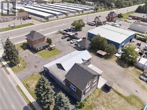 Aerial perspective of multiple structures and paved parking areas - 1360 Rymal Road E, Hamilton, ON 