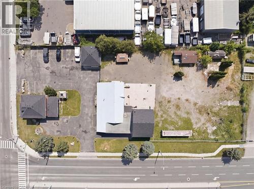 Commercial property featuring multiple structures, paved parking areas, and a substantial undeveloped lot - 1360 Rymal Road E, Hamilton, ON 
