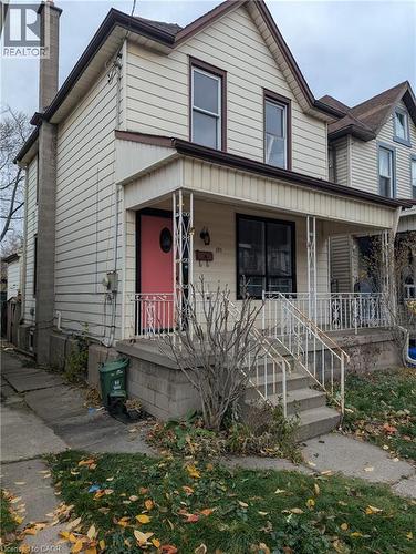 View of front of property featuring a chimney and a porch - 151 Gibson Avenue, Hamilton, ON - Outdoor With Deck Patio Veranda